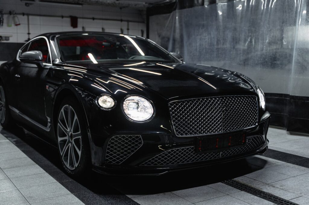 pexels-photo-6872163 Sleek black luxury car in a modern indoor car wash setting, showcasing elegance and sophistication.